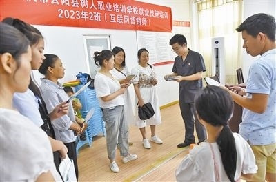  圖③：法院干警現(xiàn)場指導鄉(xiāng)村“代理家長”如何正確管護留守兒童。