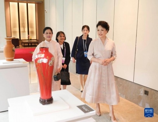 7月27日下午，國家主席習(xí)近平夫人彭麗媛在四川成都會(huì)見陪同印度尼西亞總統(tǒng)佐科來華出席第31屆世界大學(xué)生夏季運(yùn)動(dòng)會(huì)開幕式并訪華的總統(tǒng)夫人伊莉亞娜。這是彭麗媛和伊莉亞娜欣賞成都特色非遺工藝品。新華社記者 丁林 攝