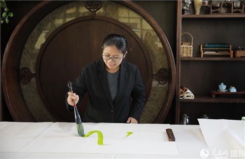 緬甸駐華大使館副館長、公使銜參贊杜欣瑪泰參加《五百筆·瀾湄合作》集體藝術(shù)創(chuàng)作。人民網(wǎng)王婧攝