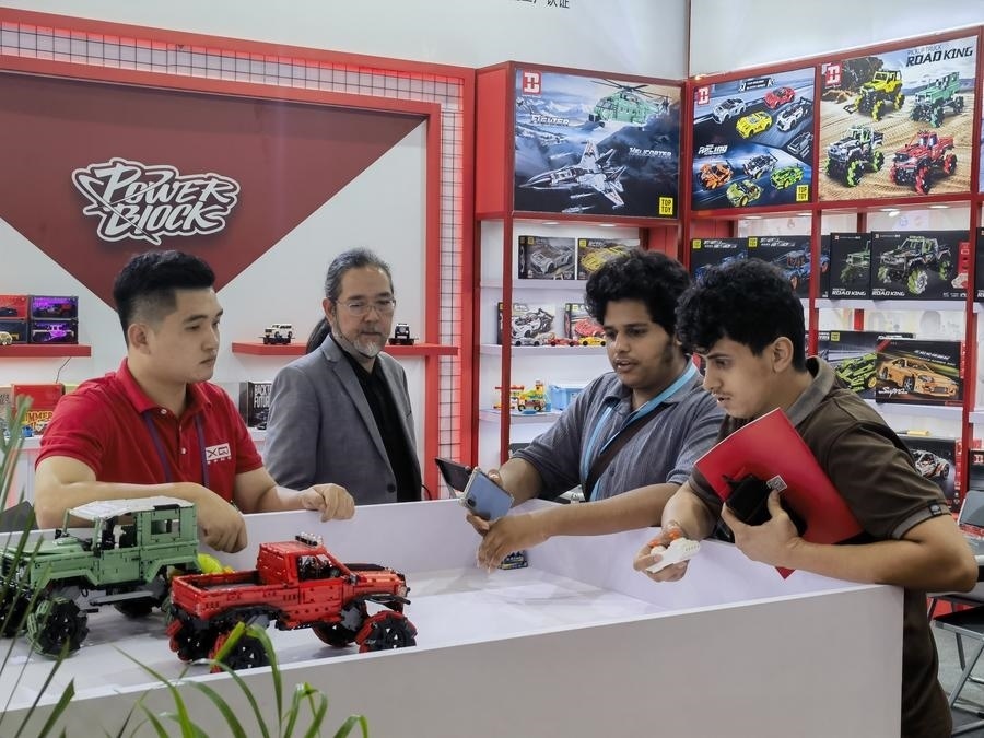 在第135屆廣交會第三期現(xiàn)場，采購商在廣東信宇科技股份有限公司展位選購、體驗積木遙控車產(chǎn)品（5月2日攝）。新華社記者 洪澤華 攝