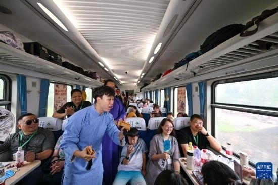 9月7日，相聲演員在S910列車(chē)上為旅客表演快板。