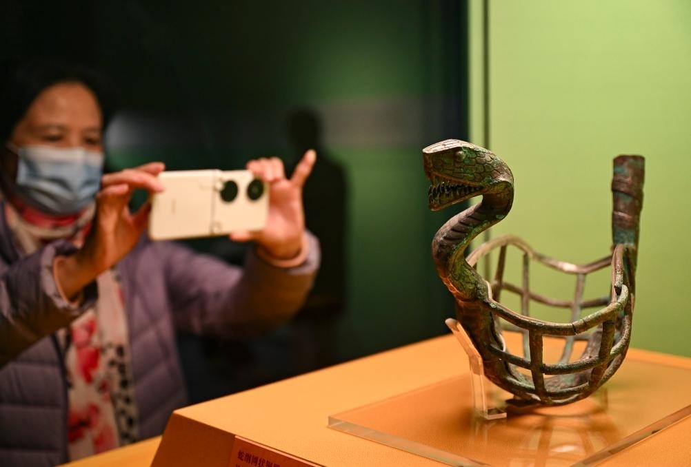 1月14日，觀眾在上海博物館蛇年迎春展拍攝展品蛇綱網(wǎng)狀銅器。新華社發(fā)（陳浩明攝）