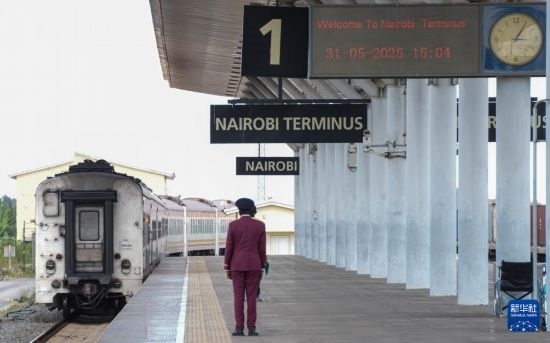 5月31日，在蒙內鐵路內羅畢站，工作人員目送開往蒙巴薩的E2次列車駛離站臺。新華社記者 李亞輝 攝
