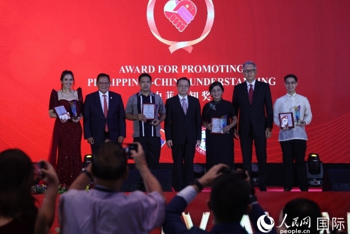 黃溪連大使和菲中了解協(xié)會主席與榮獲“友誼獎”的獲獎者合影留念。人民網(wǎng)記者 樊帆攝